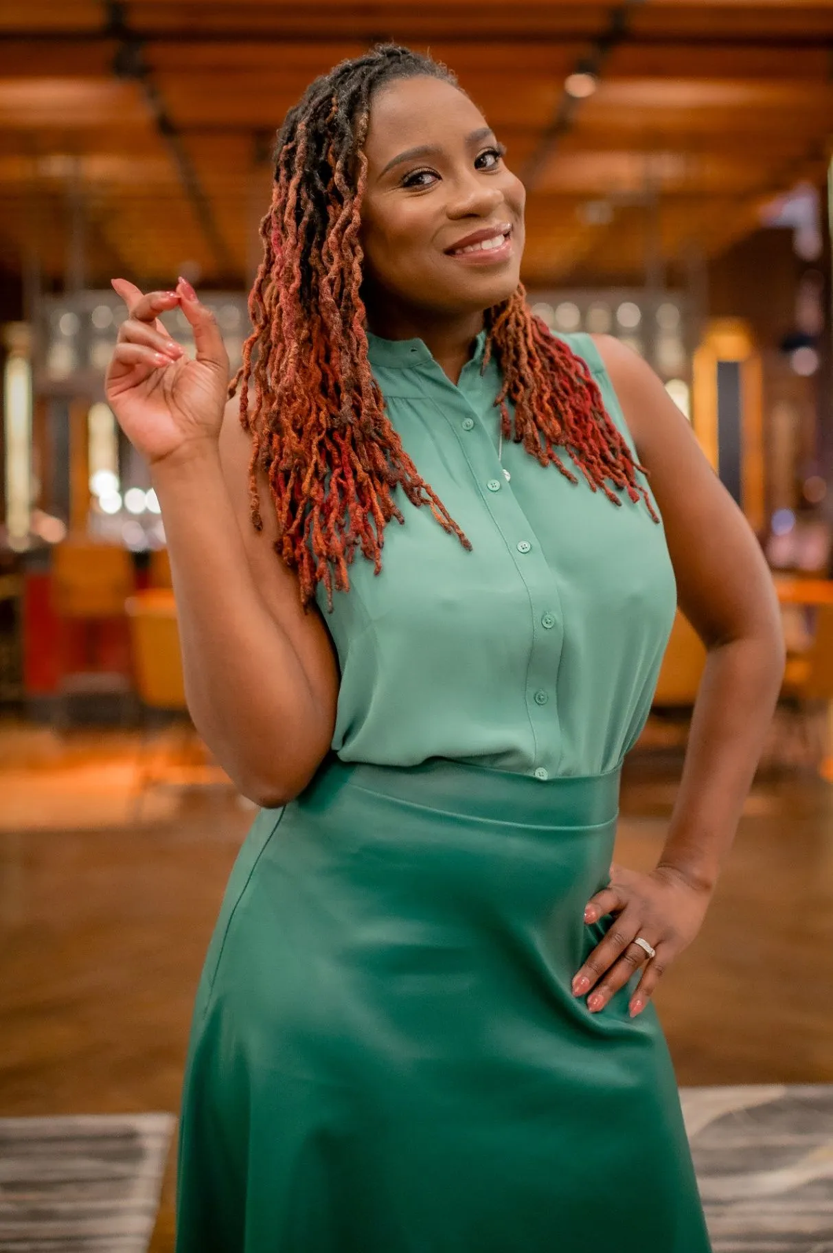 Atiya S. Brown smiling and speaking to the camera